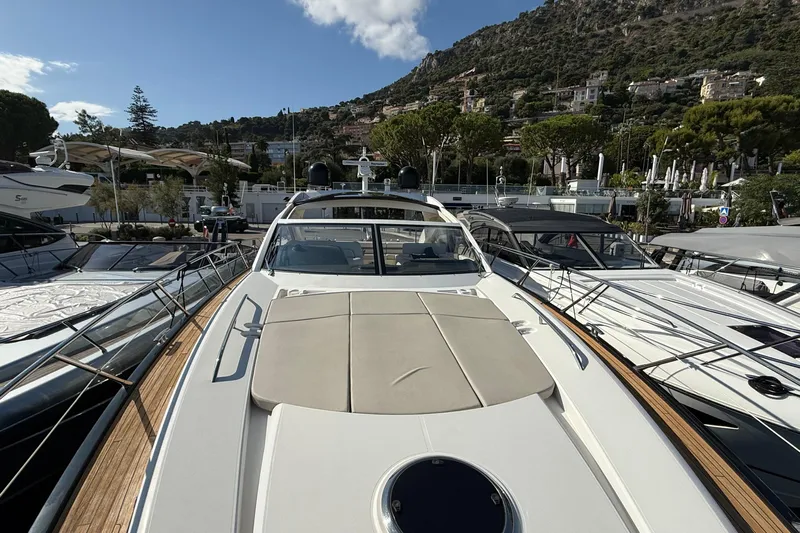 Helios Yacht Photos Pics 2010 Sunseeker Predator 60 yacht docked in a scenic marina setting.