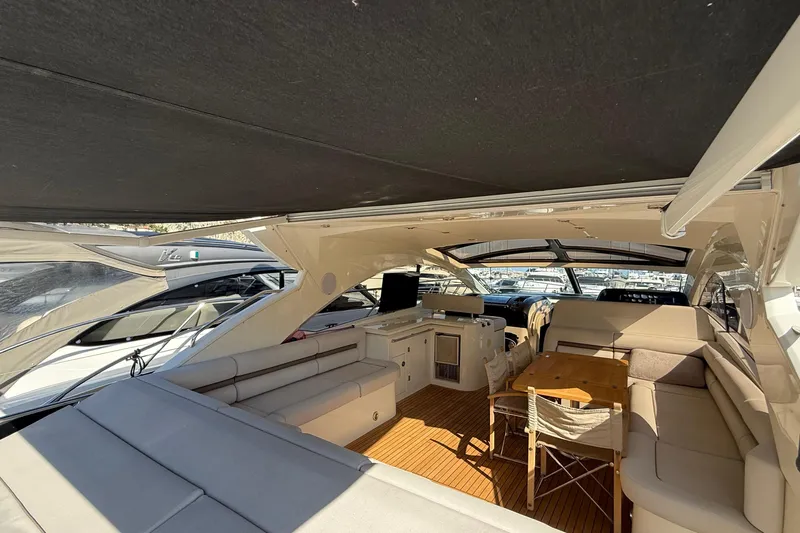 Helios Yacht Photos Pics Luxurious interior of 2010 Sunseeker Predator 60 yacht with spacious seating and wooden table.