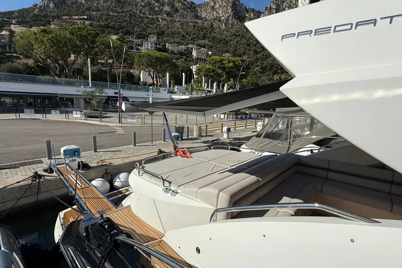 Helios Yacht Photos Pics Luxury Sunseeker Predator 60 yacht docked at marina, 2010 model, scenic mountain backdrop.