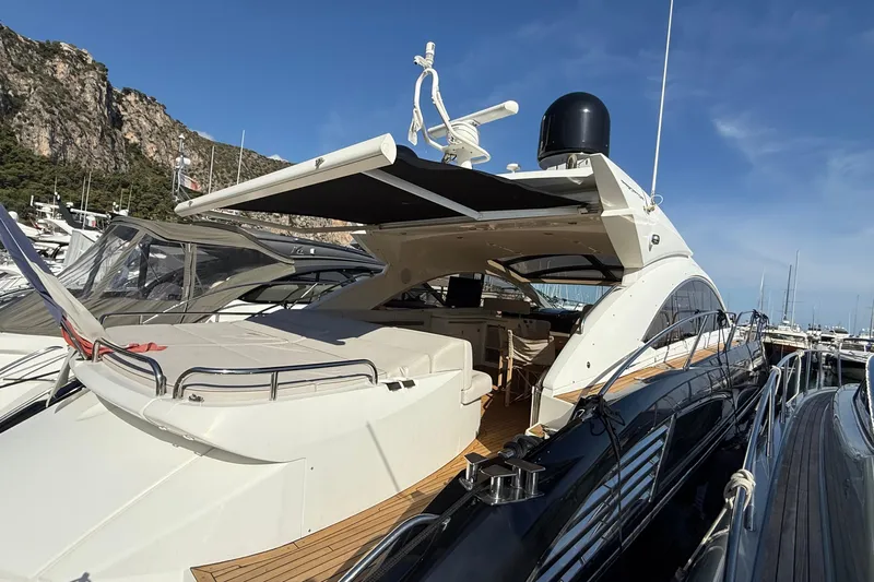 Helios Yacht Photos Pics Luxury Sunseeker Predator 60 yacht, 2010 model, docked in a scenic marina.