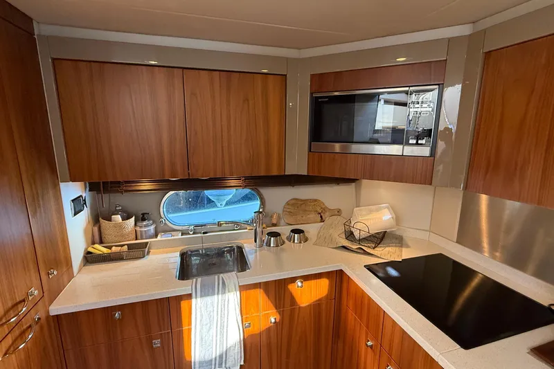 Helios Yacht Photos Pics Luxurious Sunseeker Predator 60 yacht kitchen with modern appliances and wood cabinetry, 2010 model.