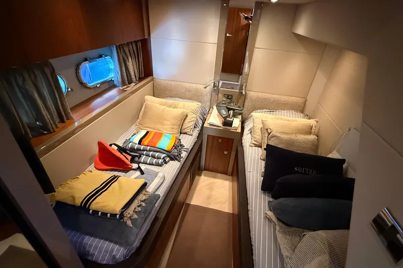 Helios Yacht Photos Pics Luxurious twin cabin interior of 2010 Sunseeker Predator 60 yacht with cozy bedding.