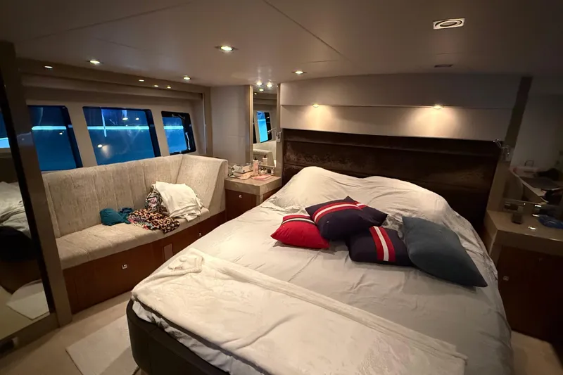 Helios Yacht Photos Pics Luxurious bedroom interior of 2010 Sunseeker Predator 60 yacht with cozy seating and stylish decor.