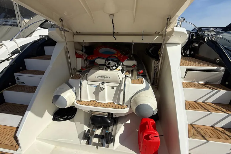 Helios Yacht Photos Pics 2010 Sunseeker Predator 60 yacht with Turbojet tender in storage compartment.