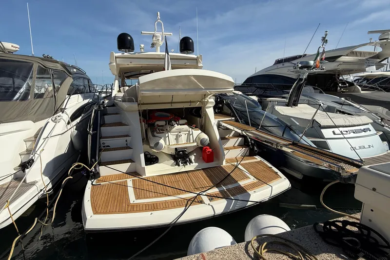 Helios Yacht Photos Pics 2010 Sunseeker Predator 60 yacht docked among other luxury boats.