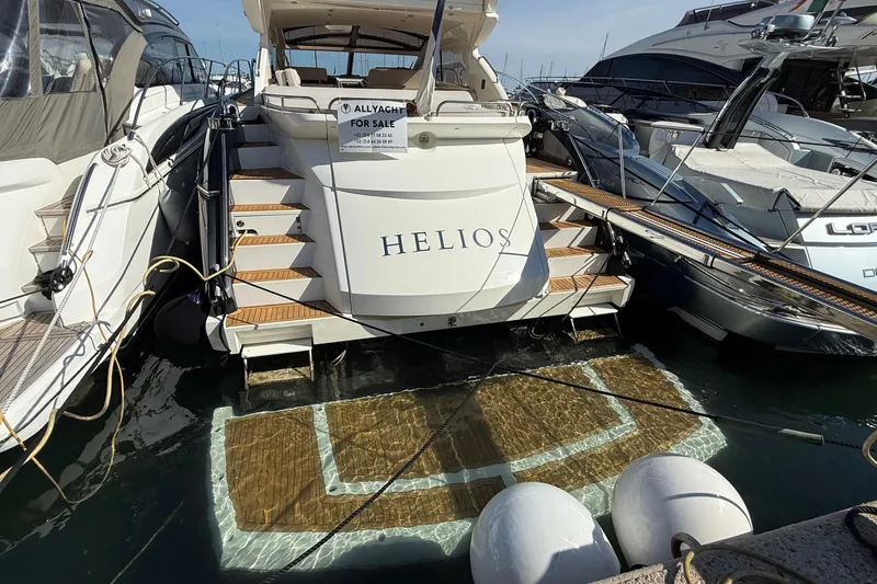 Helios Yacht Photos Pics Sunseeker Predator 60 yacht, 2010 model, docked with "For Sale" sign.