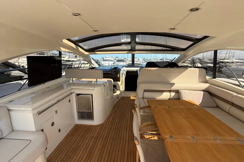 Helios Yacht Photos Pics Luxurious interior of 2010 Sunseeker Predator 60 yacht with elegant seating and wooden flooring.