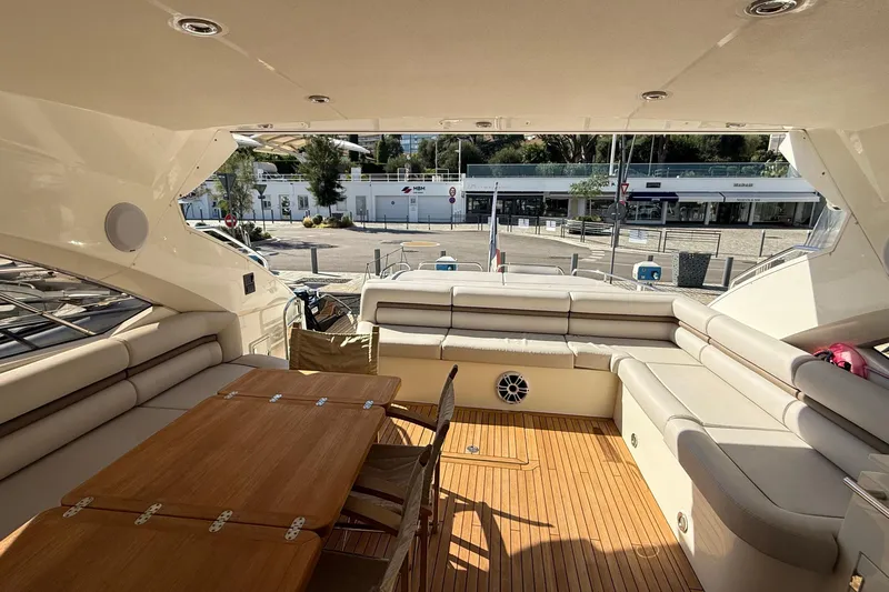 Helios Yacht Photos Pics Luxurious Sunseeker Predator 60 yacht interior, featuring elegant seating and wooden table, 2010 model.