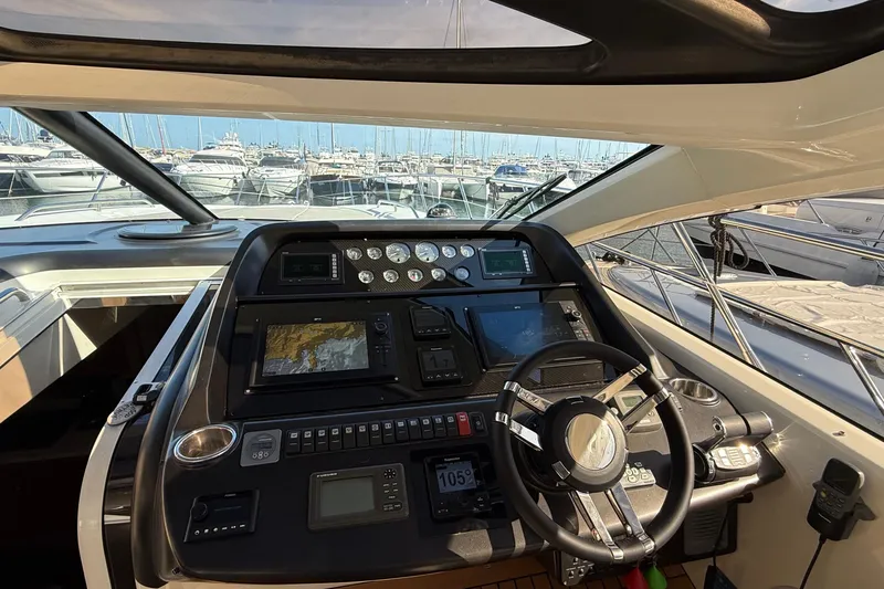 Helios Yacht Photos Pics Cockpit of 2010 Sunseeker Predator 60 yacht with advanced navigation controls and steering wheel.