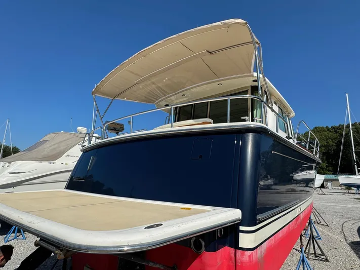  Yacht Photos Pics 2012 Sabre 48 Salon Express yacht with canopy, docked on land.