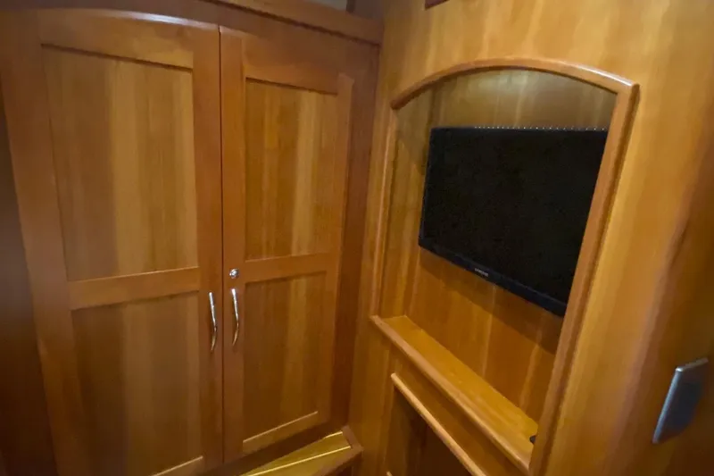  Yacht Photos Pics 2012 Sabre 48 Salon Express interior with wooden cabinetry and mounted TV.