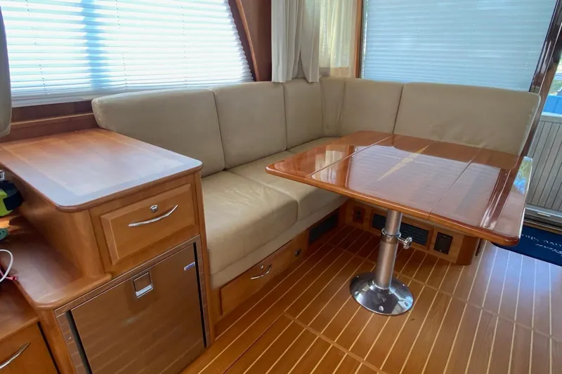  Yacht Photos Pics 2012 Sabre 48 Salon Express interior with beige seating and wooden table.