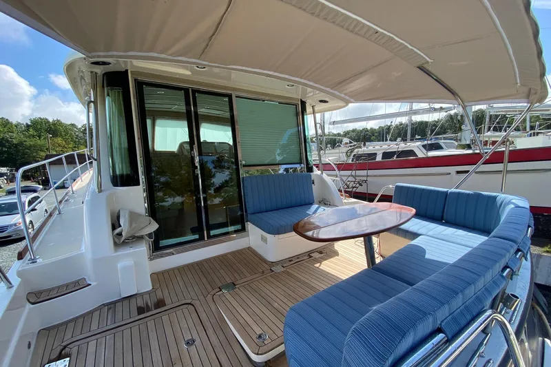  Yacht Photos Pics 2012 Sabre 48 Salon Express yacht with blue seating and wooden deck.