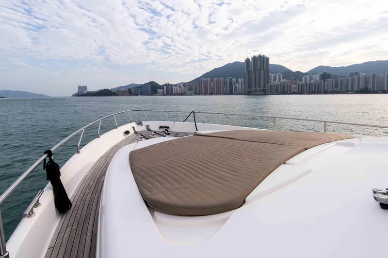  Yacht Photos Pics 2016 Ferretti Yachts 870 cruising with city skyline and mountains in the background.