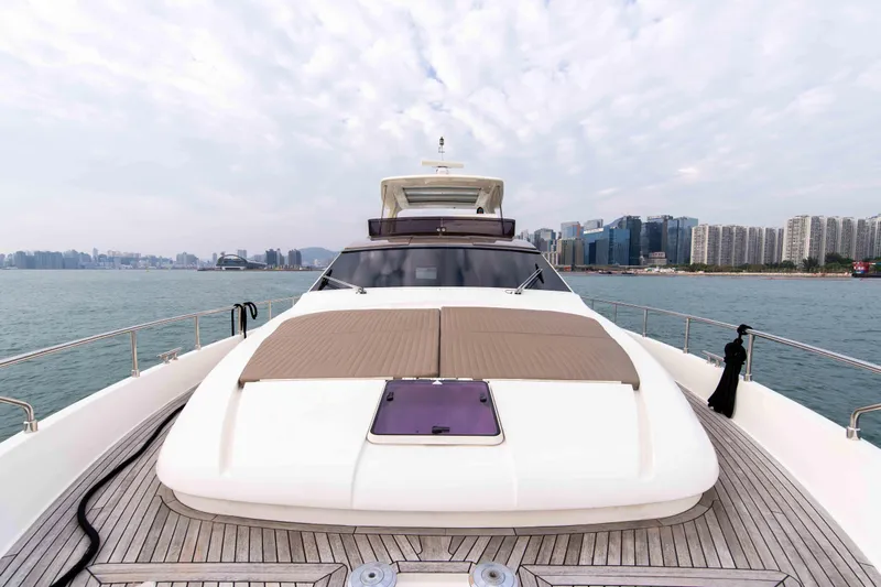  Yacht Photos Pics Luxurious 2016 Ferretti Yachts 870 on calm waters with city skyline backdrop.