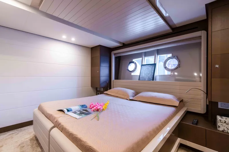  Yacht Photos Pics Luxurious bedroom interior of 2016 Ferretti Yachts 870 with elegant decor and porthole windows.