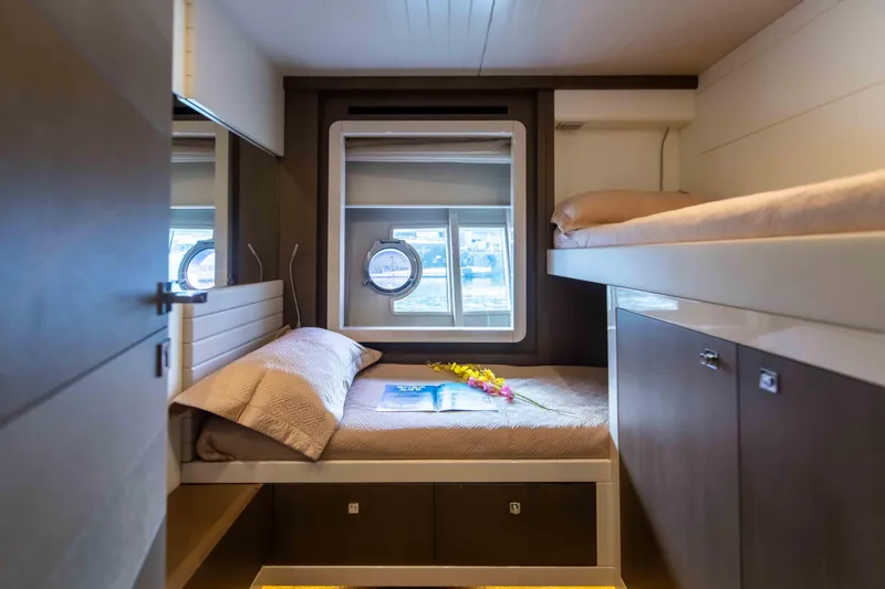  Yacht Photos Pics Luxurious cabin interior of 2016 Ferretti Yachts 870 with cozy beds and porthole view.