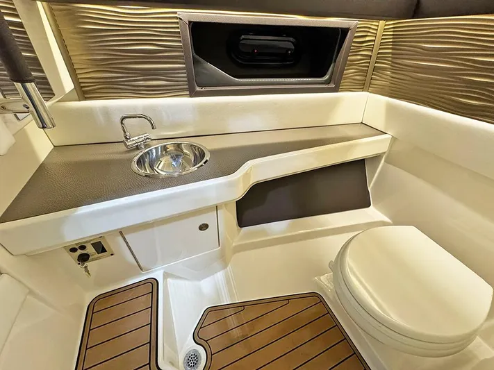  Yacht Photos Pics 2017 Sea Ray SLX 310 boat interior with sink, toilet, and wood accents.