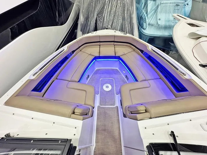  Yacht Photos Pics 2017 Sea Ray SLX 310 boat interior with blue LED lighting and beige seating.