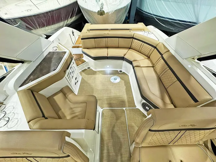  Yacht Photos Pics Luxurious interior of 2017 Sea Ray SLX 310 boat with tan leather seating.