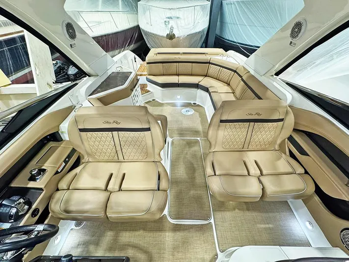  Yacht Photos Pics Luxurious interior of 2017 Sea Ray SLX 310 boat with tan leather seating.
