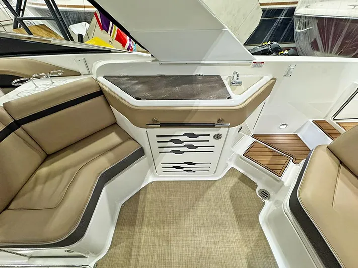  Yacht Photos Pics 2017 Sea Ray SLX 310 interior with beige seating, kitchenette, and wood accents.