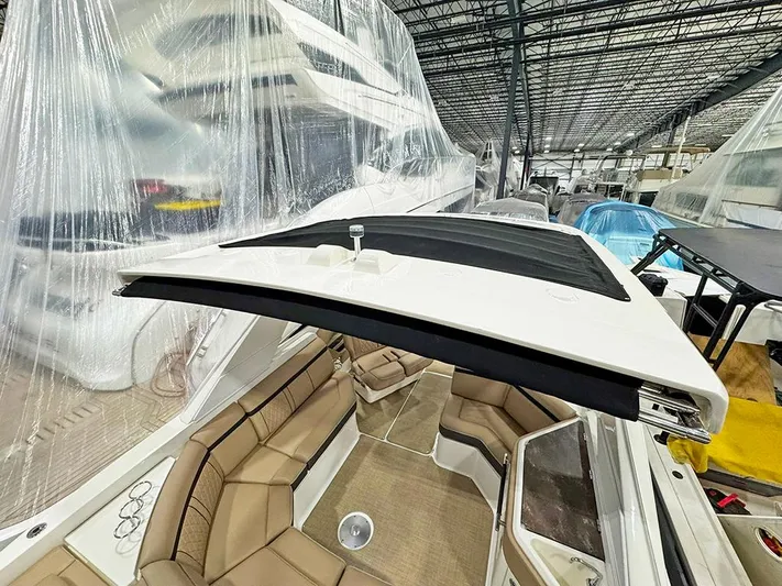  Yacht Photos Pics 2017 Sea Ray SLX 310 boat with tan seating, stored indoors under protective covers.