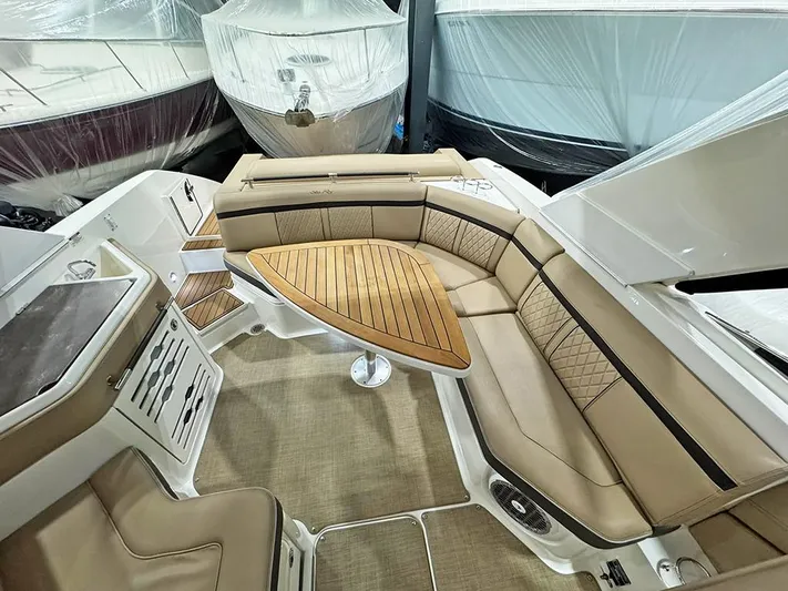  Yacht Photos Pics 2017 Sea Ray SLX 310 boat interior with tan seating and wooden table.