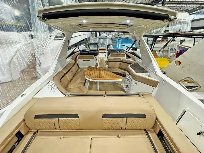  Yacht Photos Pics 2017 Sea Ray SLX 310 boat interior with tan seating and wooden table.