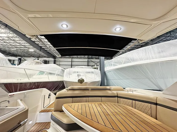  Yacht Photos Pics 2017 Sea Ray SLX 310 interior with wood accents, docked in a covered marina.