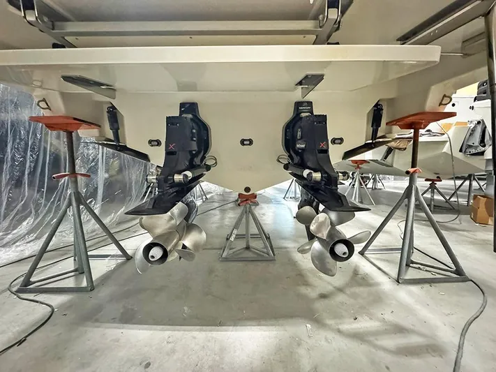  Yacht Photos Pics 2017 Sea Ray SLX 310 boat on stands, showcasing dual propellers in a storage facility.