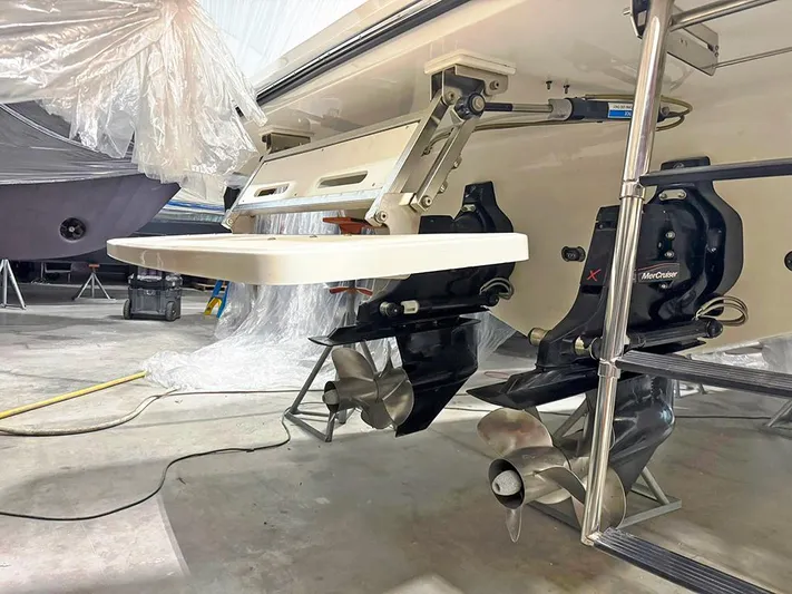  Yacht Photos Pics 2017 Sea Ray SLX 310 boat with dual propellers and swim platform in a storage facility.