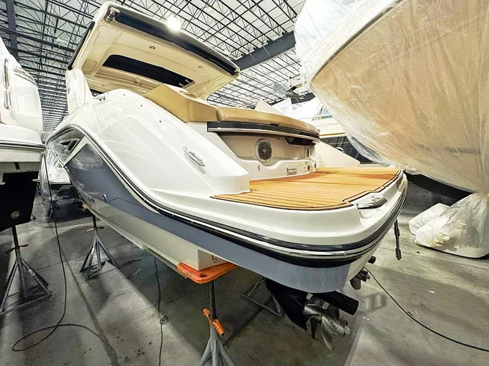  Yacht Photos Pics 2017 Sea Ray SLX 310 boat in storage, showcasing sleek design and spacious deck.