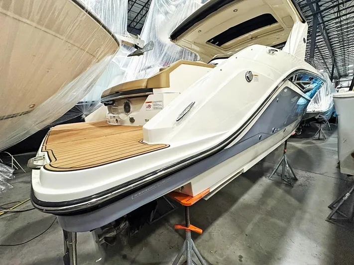  Yacht Photos Pics 2017 Sea Ray SLX 310 boat in storage, showcasing sleek design and spacious deck.