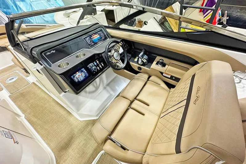  Yacht Photos Pics 2017 Sea Ray SLX 310 boat interior with beige seating and modern dashboard controls.