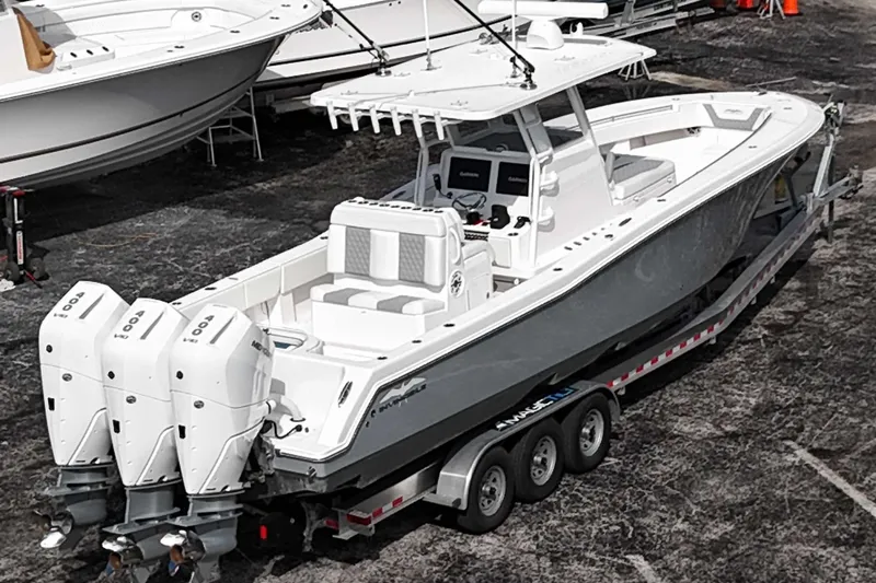  Yacht Photos Pics 2025 Invincible 36 Open Fisherman boat with triple outboard engines on a trailer.