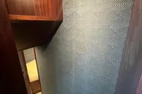 Staircase with textured blue wall and wooden accents, Custom model 22, 1958.