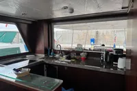 Interior of a 1958 Custom model 22 boat with modern kitchen amenities.
