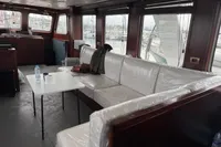 Interior of a 1958 Custom model 22 boat with white seating and a small table.