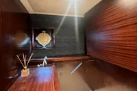 Vintage 1958 Custom interior with wooden paneling and porthole, featuring elegant decor elements.