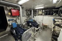 Engine room of a 1958 Custom model 22, featuring machinery and piping.