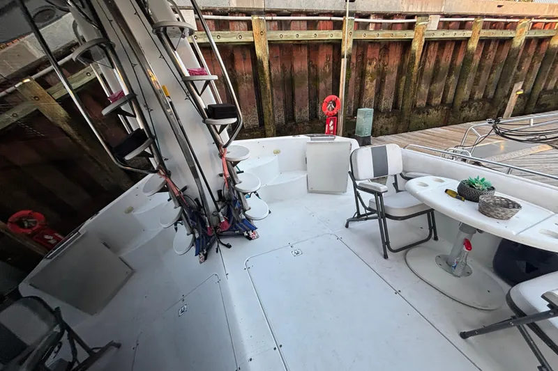 Moonstruck Yacht Photos Pics 1998 Carver 530 Voyager Pilothouse yacht deck with seating and fishing rods.