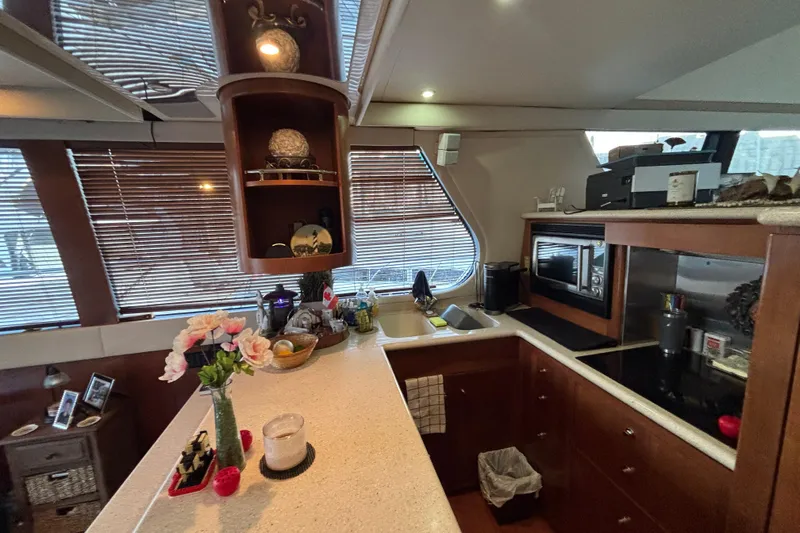 Moonstruck Yacht Photos Pics Luxurious kitchen interior of 1998 Carver 530 Voyager Pilothouse yacht with modern amenities.