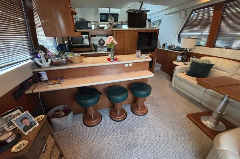Moonstruck Yacht Photos Pics Interior of 1998 Carver 530 Voyager Pilothouse with cozy seating and wooden accents.
