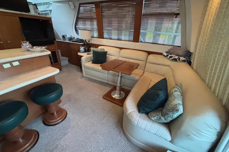 Moonstruck Yacht Photos Pics Luxurious interior of 1998 Carver 530 Voyager Pilothouse with plush seating and elegant decor.