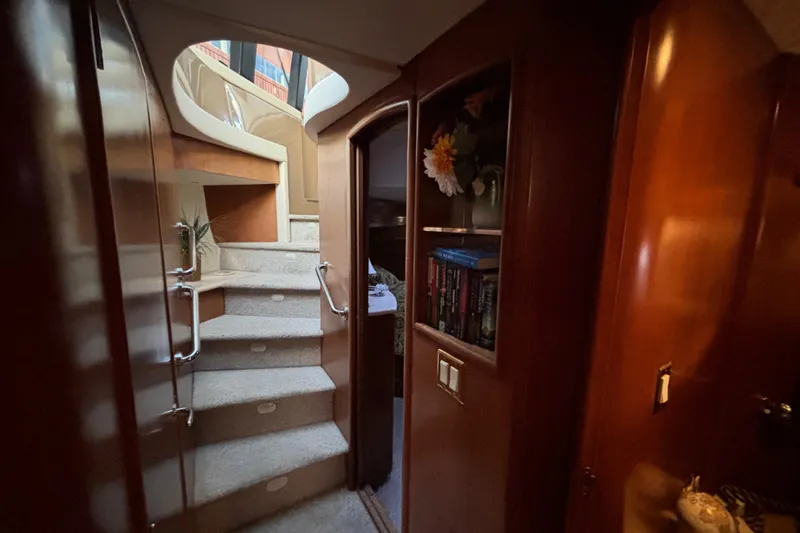 Moonstruck Yacht Photos Pics Interior of 1998 Carver 530 Voyager Pilothouse with staircase and wooden cabinetry.