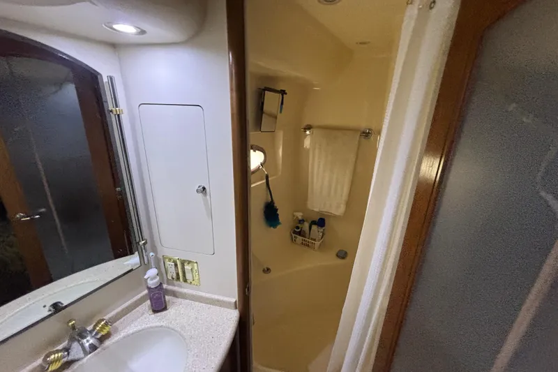 Moonstruck Yacht Photos Pics Bathroom interior of 1998 Carver 530 Voyager Pilothouse yacht, featuring sink and shower.
