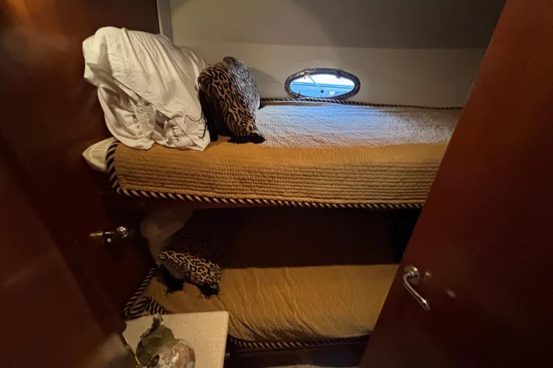 Moonstruck Yacht Photos Pics Bunk beds in 1998 Carver 530 Voyager Pilothouse cabin with leopard print pillows.