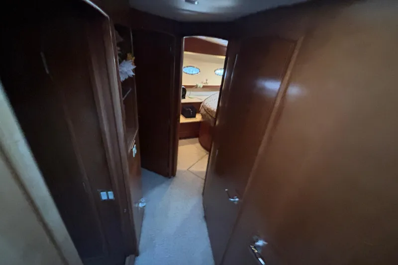 Moonstruck Yacht Photos Pics Interior view of 1998 Carver 530 Voyager Pilothouse, featuring wooden cabinetry and cozy bedroom.