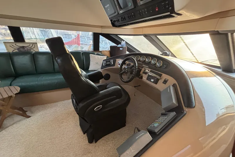 Moonstruck Yacht Photos Pics Interior of 1998 Carver 530 Voyager Pilothouse with helm and seating area.